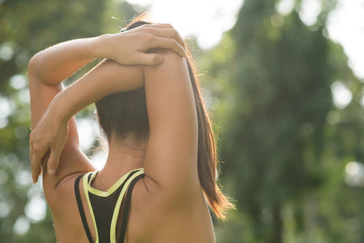 Girl outside stretching to relieve and prevent joint pain